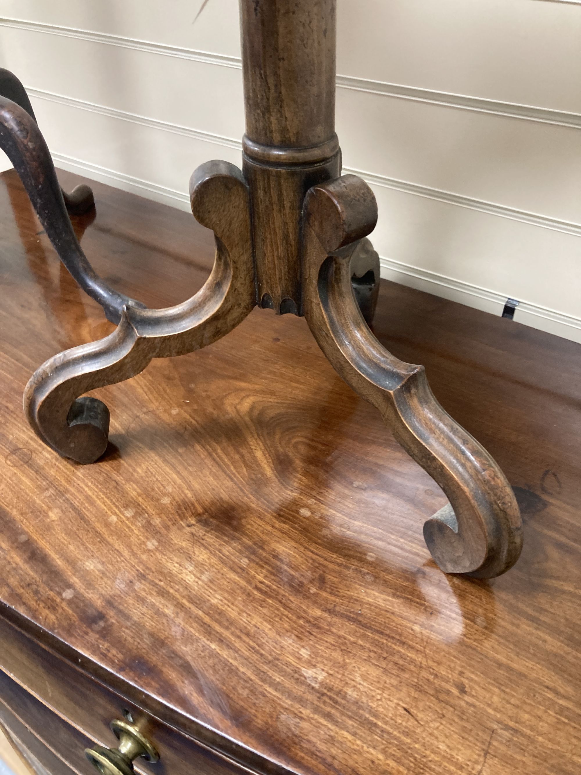 A carved walnut occasional table on tripod base, diameter 38cm, height 47cm